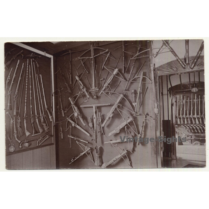 Gun Shop Exhibition: Crossbows, Rifles & Pistols (Vintage RPPC Sepia ~1910s/1920s)