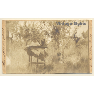 Little Baby & Teddy Bear In Garden / Highchair (Vintage RPPC 1907)