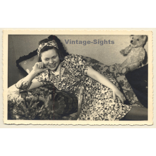 Cheeky Young Woman In Flowered Dress & Teddy Bear On Her Knees (Vintage RPPC 1941)
