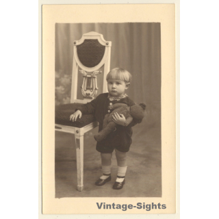 Shorthaired Baby Girl With Teddy Bear On Arm (Vintage RPPC 1920s/1930s)