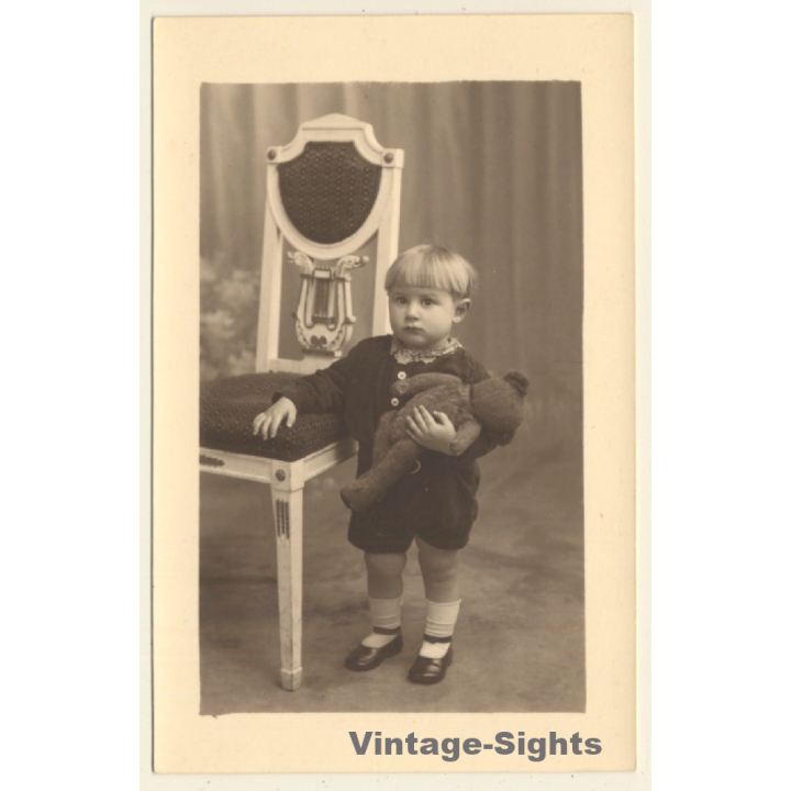 Shorthaired Baby Girl With Teddy Bear On Arm (Vintage RPPC 1920s/1930s)