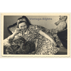 Cheeky Young Woman In Flowered Dress & Teddy Bear On Her Knees (Vintage RPPC 1941)