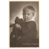 Sulky Baby Girl Holds Her Teddy Bear (Vintage RPPC ~1920s/1930s)